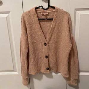 Pink cardigan.